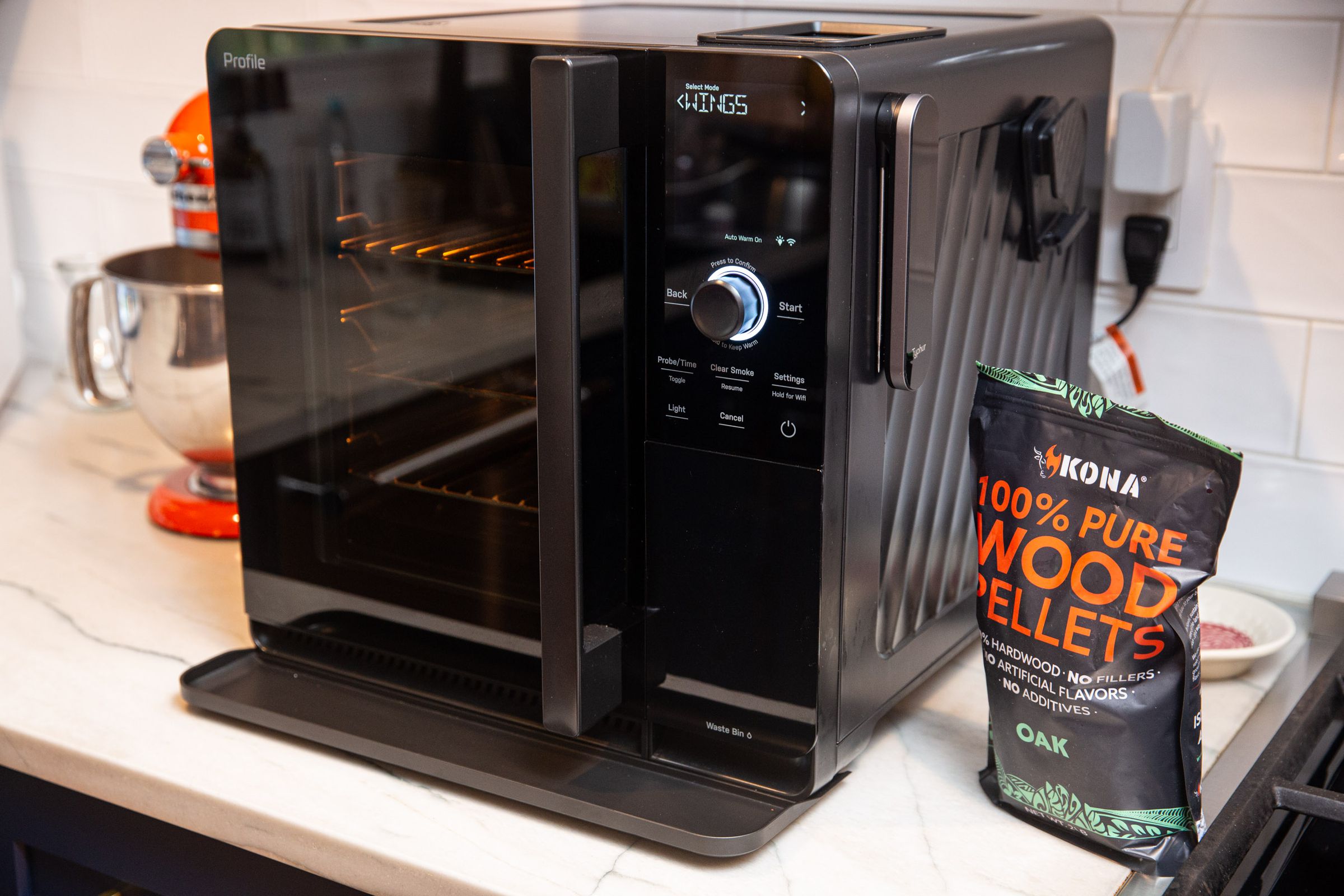 A black indoor smoker on a white countertop.