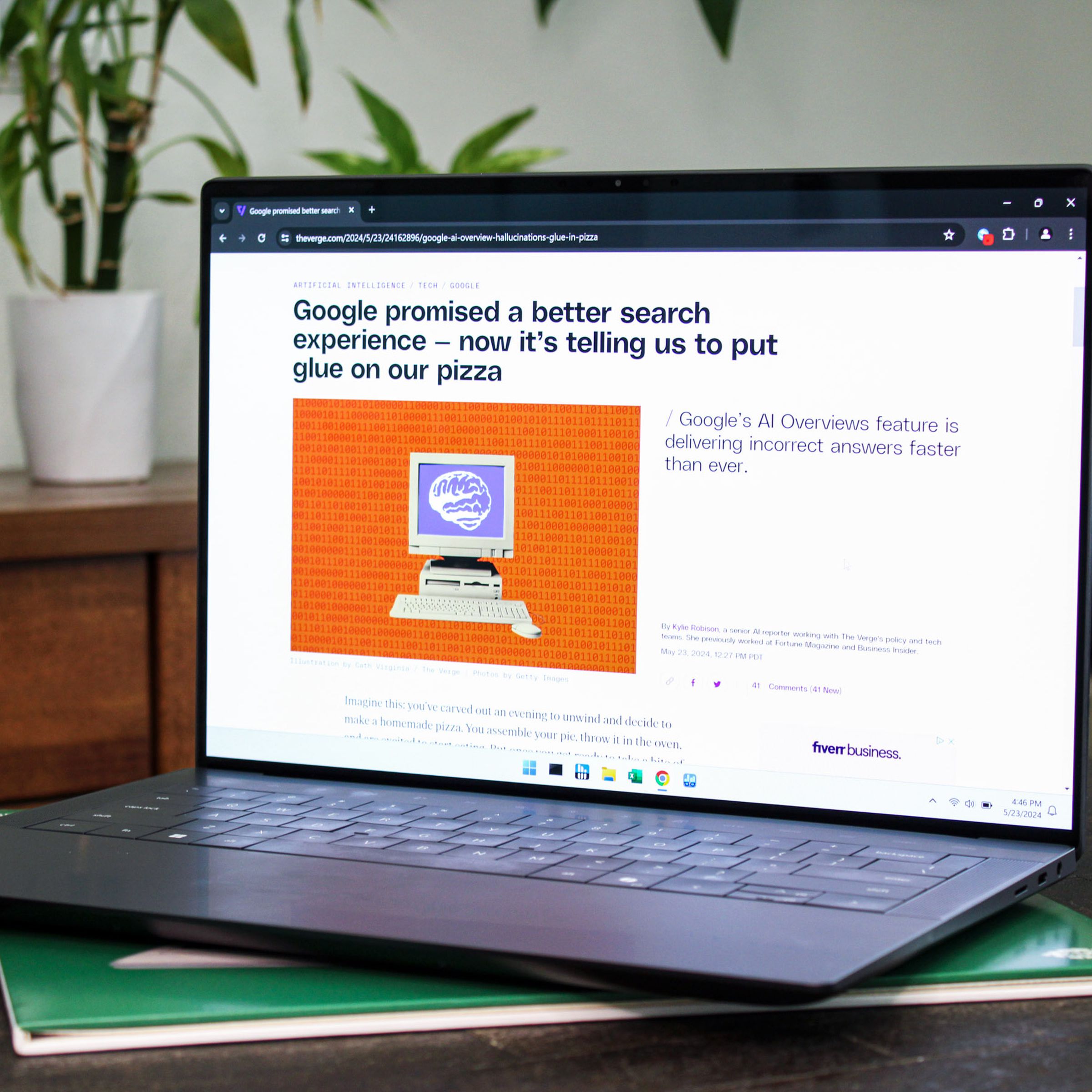 An open and powered-on laptop sitting on top of a table.