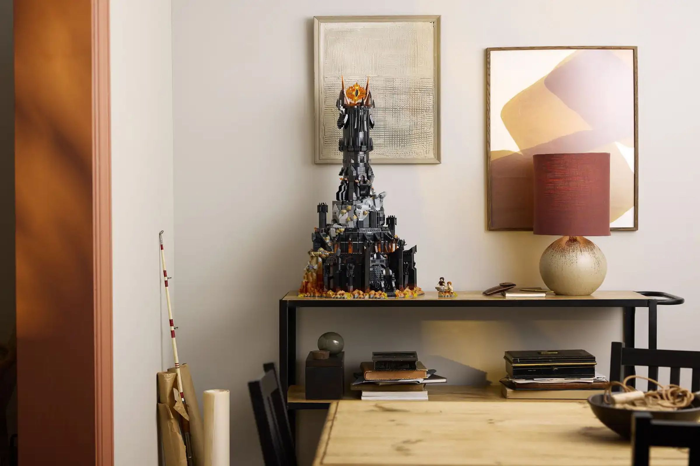 A wide-angle shot of Lego’s Barad-dûr set sitting on a table beside a lamp.