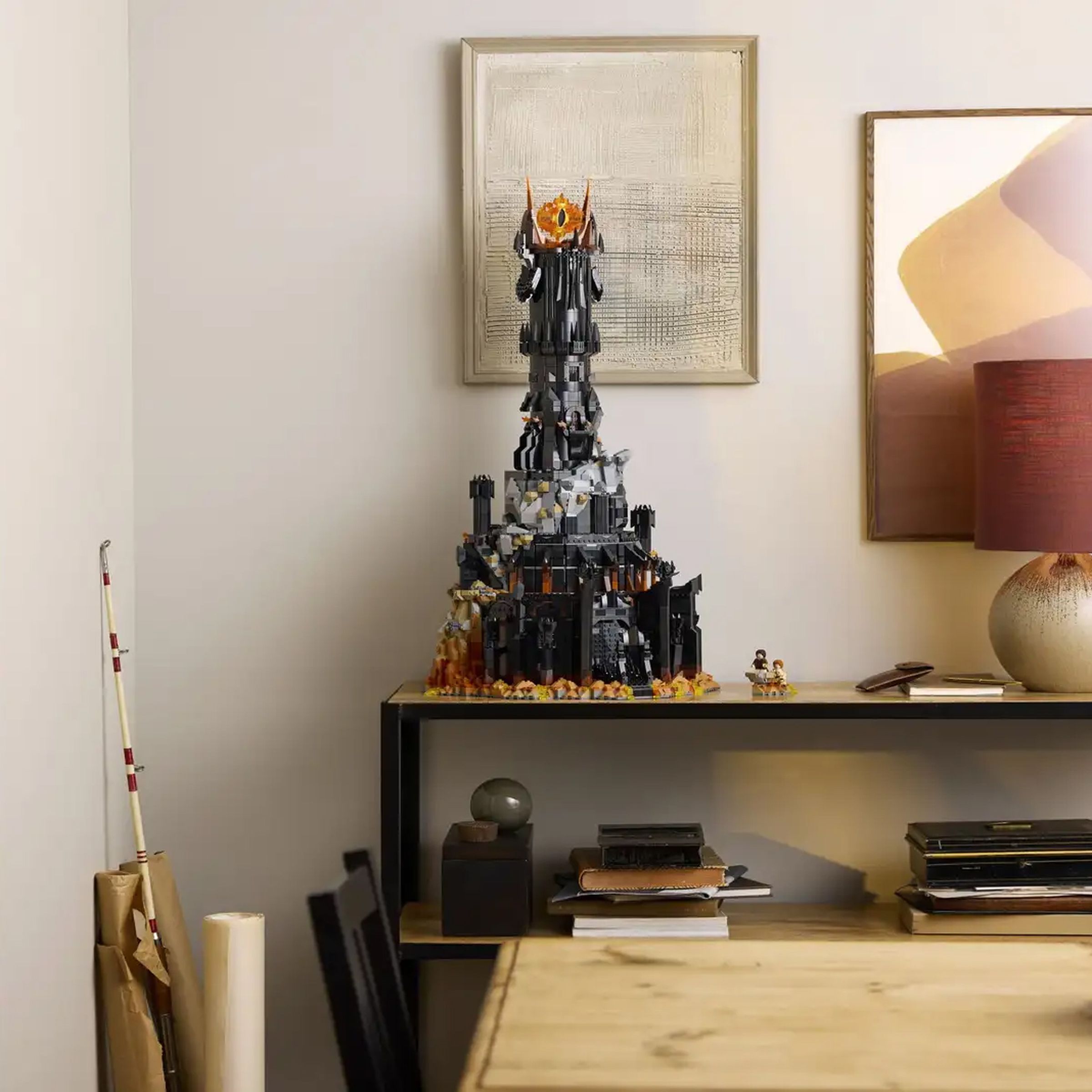 A wide-angle shot of Lego’s Barad-dûr set sitting on a table beside a lamp.